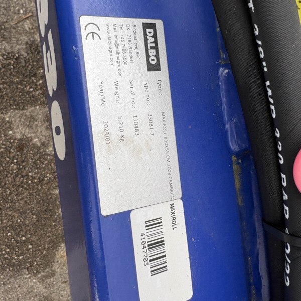 Close-up of a blue metal surface with a silver label showing the brand 'DALBO' and a barcode.