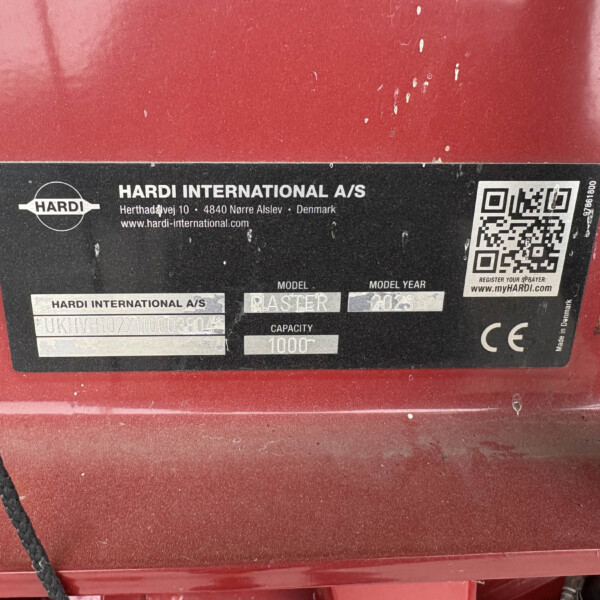Label on red machinery: Hardi International A/S with QR code and company details (Denmark).