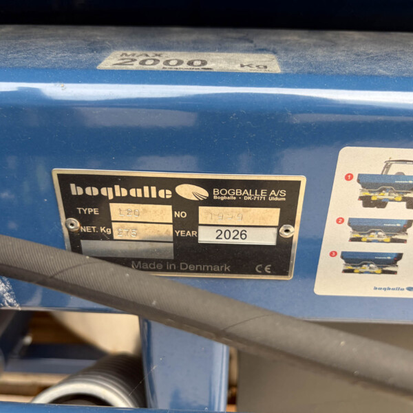 Close-up of a blue agricultural machine with a metal data plate showing model L20 and year 2026, Made in Denmark.