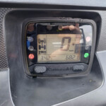 Close-up of a Kawasaki motorcycle instrument cluster showing speed at 0 mph with gear indicator and warning lights visible.