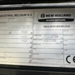 Identification plate with CNH Industrial Belgium and New Holland Agriculture branding on a metal surface