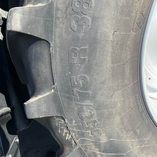 Close‑up of a black car tire with large embossed lettering reading 'GOODYEAR' and visible scuffs/dust.