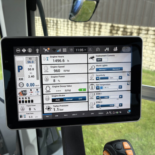 Tablet mounted in a vehicle showing an on-screen diagnostic dashboard with engine hours, RPM, and various instrumentation panels for vehicle telemetry.