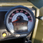 Close-up of a Polaris off-road vehicle speedometer cluster with red numbers (0–70 mph) and digital readout.