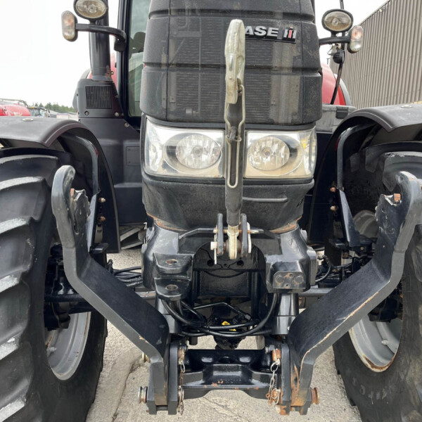 Front view of a Case IH tractor with large dual tires, two headlights, and a central hitch between the wheels.