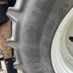 Close-up of a large off-road tire with deep tread and the Michelin branding on the sidewall, next to a rusted metal step.