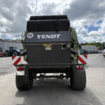 Rear view of a large green Fendt agricultural machine with oversized tires in a farm equipment yard, 40 badge visible.