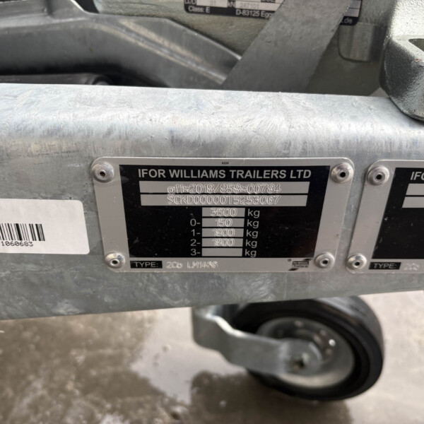 Metal trailer frame with identification plates reading 'IFOR WILLIAMS TRAILERS LTD' and weight specs; shows model/type and serial data.