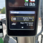 Display panel reading 'Readings' with engine hours 1870.5 h shown on an industrial machine screen in a vehicle cab