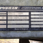 Metal identification plate reading 'JOSKIN' with model details and weights, mounted on a dark blue surface with screws (Belgian-made)