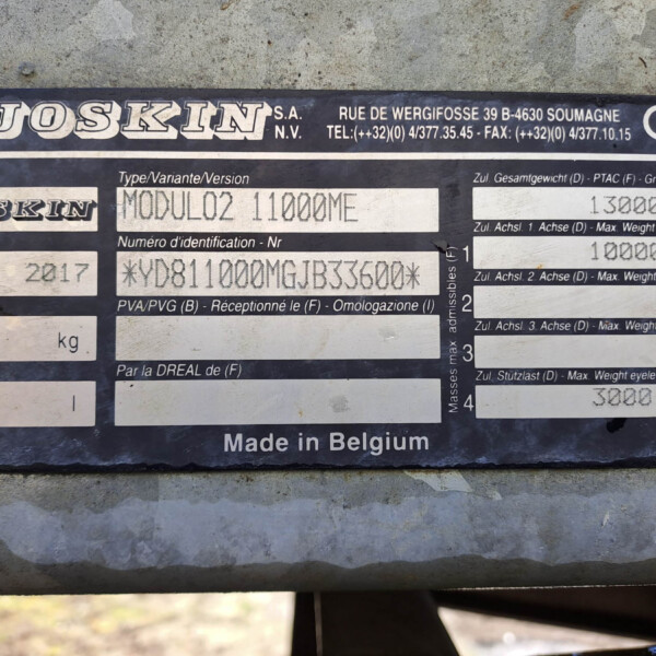 Metal identification plate reading 'JOSKIN' with model details and weights, mounted on a dark blue surface with screws (Belgian-made)