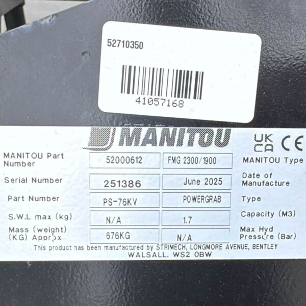 Close-up of identification labels on a dark metal surface; shows Manitou branding and part/serial numbers with a barcode.
