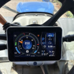 View from rider's perspective of a motorcycle dashboard with a digital instrument cluster displaying speed, fuel, and RPM.