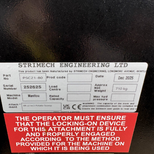 Close-up of a metal equipment label showing 'STRIMECH ENGINEERING LTD' with a red safety warning panel beneath; indicates part and date fields.