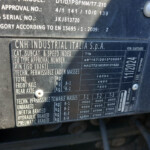 Close-up of a metal vehicle data plate showing CNH Industrial Italia S.p.A. and weight/specification data (vin, mass, category).