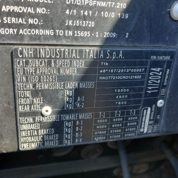 Close-up of a metal vehicle data plate showing CNH Industrial Italia S.p.A. and weight/specification data (vin, mass, category).