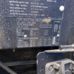 Close-up of a dusty vehicle data plate with model and VIN information from CNH Industrial Italia S.