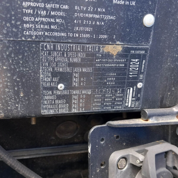 Close-up of a dusty vehicle data plate with model and VIN information from CNH Industrial Italia S.