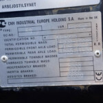 Metal data plate showing CNH Industrial Europe Holding S.A., Made in the UK, with Type 60 and various mass/axle load data.