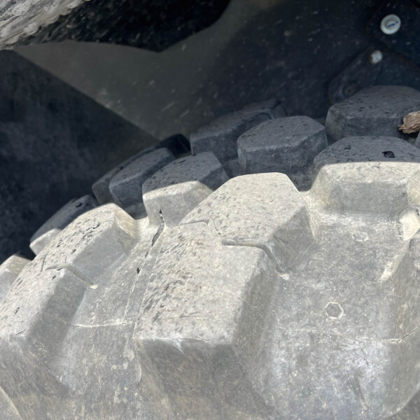 Close-up of gray interlocking concrete blocks forming a shoreline breakwater structure.
