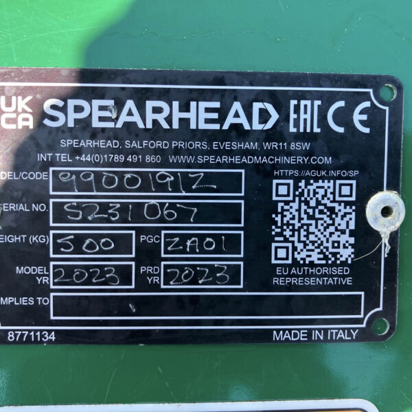 Close-up of a black metal identification plate on green equipment showing the SPEARHEAD branding, CE mark, a QR code, handwritten serial information, and 'MADE IN ITALY' at the bottom.