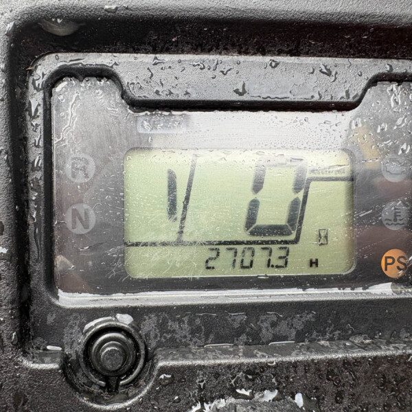 Close-up of a rugged digital display on a wet, dirty surface, with condensation obscuring the readout and a numeric value partly visible.