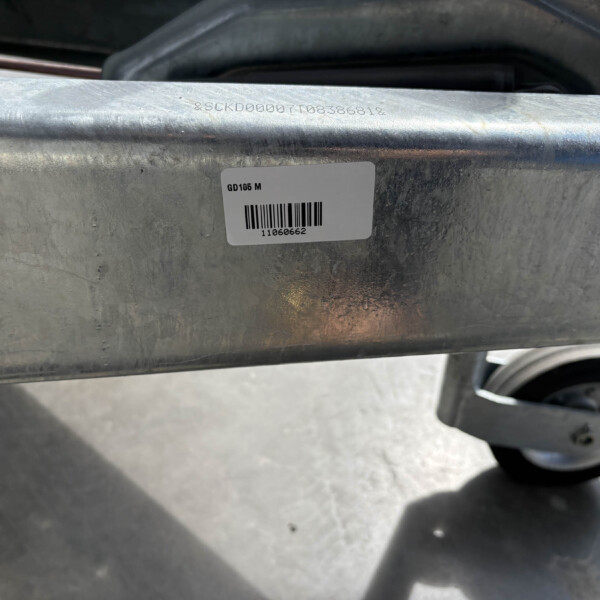 Barcode label on a weathered metal frame showing 'GD105 M' with a printed number 11060662 beneath the barcode.