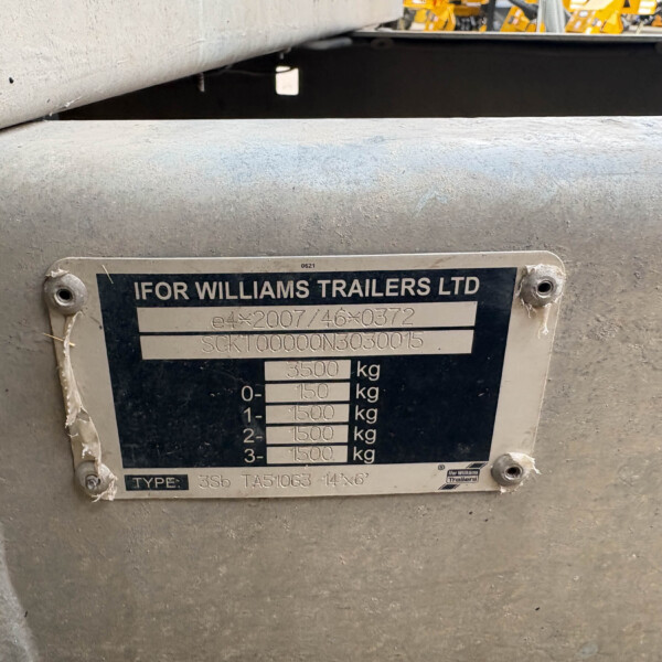 Close-up of a metal trailer identification plate reading 'IFOR WILLIAMS TRAILERS LTD' with model and weight specifications a