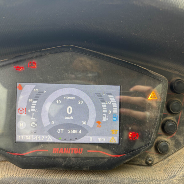 Close-up of a dusty vehicle dashboard with red warning lights and a digital speed readout at 0 km/h.