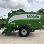 Green McHale Fusion Vario round baler with branding visible, parked on a paved lot.