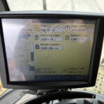 Cabin display showing combine totals: area 636.03 ha, time 245:06:25, fuel 13293.78 L, distance 1196.1 km.