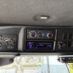 Vehicle dashboard with climate controls and a Kenwood stereo, viewed from the driver's seat.