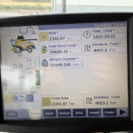 In-cab display showing harvest data: area 2341.87 ha, time 1022:28:22, distance 4653.1 km, fuel used 54680.39 L, weight 20899.548 ton (Combine Totals)