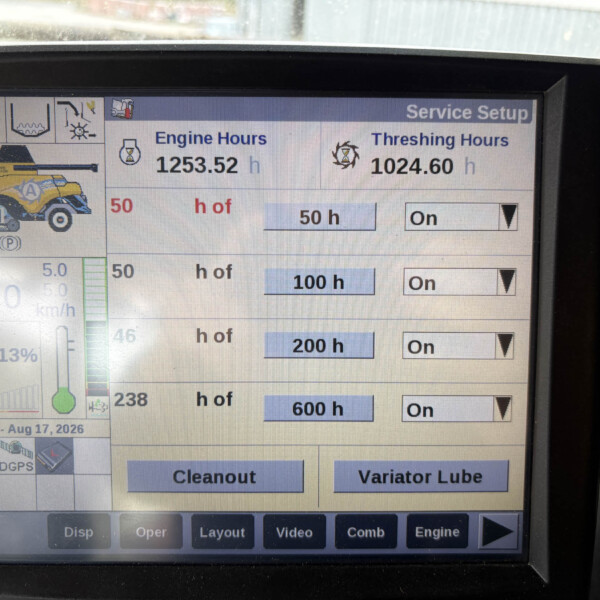 Monitor screen labeled 'Service Setup' showing Engine Hours 1253.52 h and Threshing Hours 1024.60 h with a yellow combine image on the left.