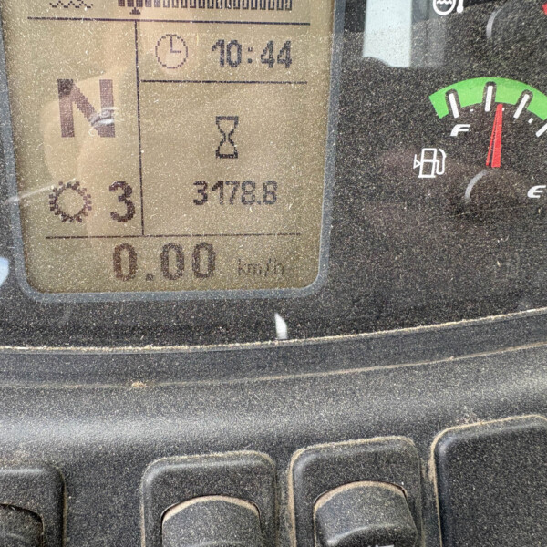 Close-up of a dusty vehicle instrument cluster showing time 10:44, fuel gauge on the right, and numeric readouts including an hourglass icon and 3172.8/kph readout.