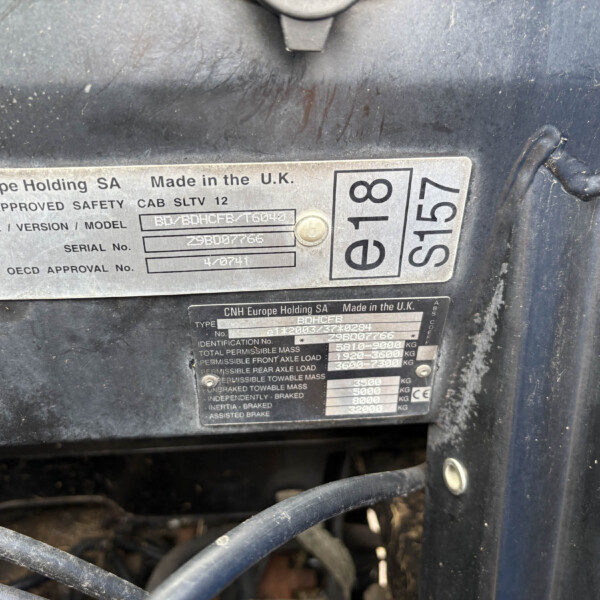 Metal identification plate on a dark, dusty surface showing 'Made in the U.K.' and serial/model information, with other codes nearby.] , but we need to craft properly.