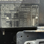 Data plate on a CNH Industrial vehicle listing weights and approvals such as total and axle masses.
