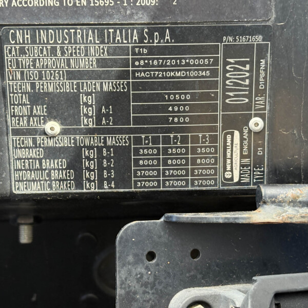 Data plate on a CNH Industrial vehicle listing weights and approvals such as total and axle masses.