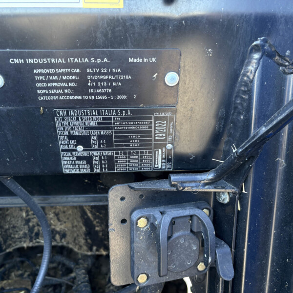 Close-up of CNH Industrial Italia data plate on a dark metal surface, showing Made in UK and model/serial numbers.