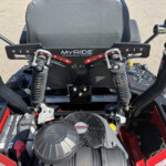 Front cockpit view of a Kawasaki vehicle showing the MyRide suspension plate, dual coil springs, handlebars, and controls.