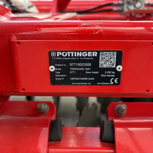 Close-up of a red PöttINGER machinery plate showing model TERRADISC 3001, chassis number and a QR code