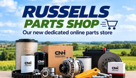 Advertising banner for Russells Parts Shop: text shows 'RUSSELLS PARTS SHOP' and 'Our new dedicated online parts store' with assorted auto parts and a shopping cart icon on a countryside backdrop.