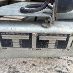 Close-up of a metal trailer coupling area with Ifor Williams Trailers Ltd branding and weight-capacity plates visible