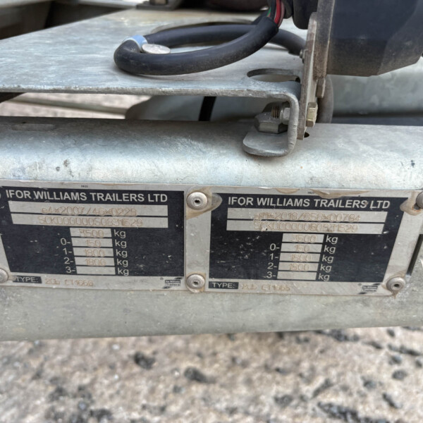 Close-up of a metal trailer coupling area with Ifor Williams Trailers Ltd branding and weight-capacity plates visible