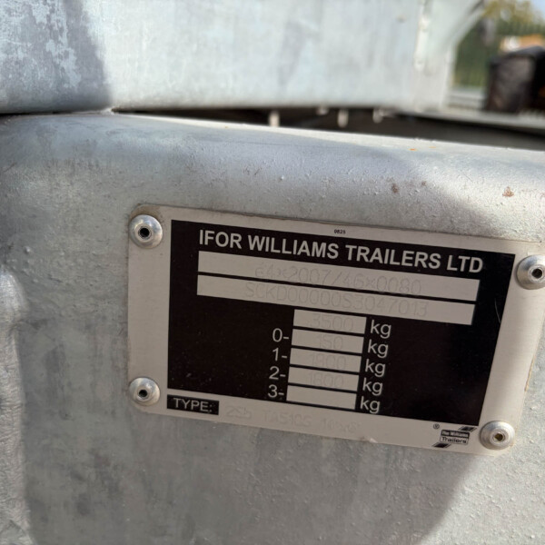 Close-up of a trailer identification plate on a gray metal frame, showing the company name IFOR WILLIAMS TRAILERS LTD and weight specifications.