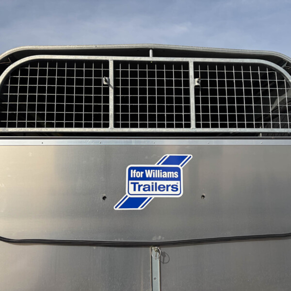 Front view of a gray trailer with a large curved metal grid grille and the Ifor Williams Trailers logo visible on the side panel.