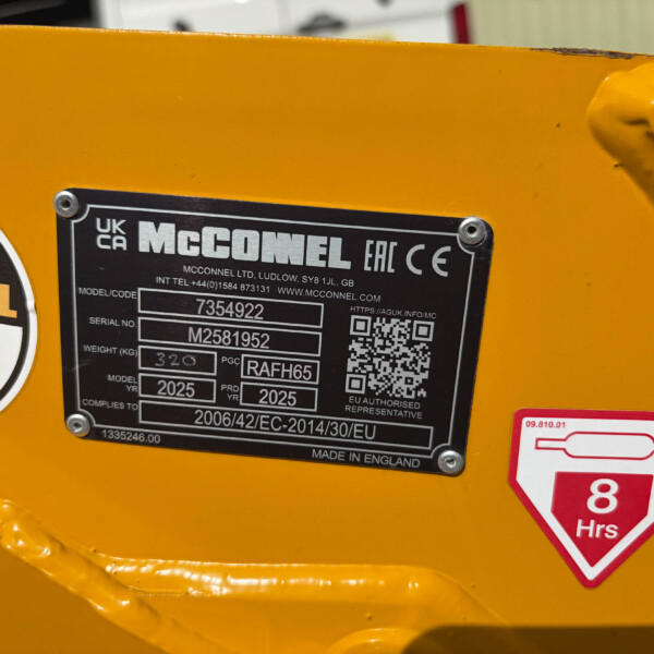 Close-up of a yellow industrial machine with a black McConnel identification plate showing model and serial details, plus a red 8 Hours safety sticker and a QR code nearby.