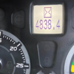 Close-up of a car instrument cluster: tachometer on the left and a small digital display showing 48.4 with an hourglass icon above it.