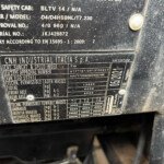 Close-up of a dusty vehicle identification plate showing CNH Industrial Italia S.p.A. and technical specs like model, approval numbers, and masses.
