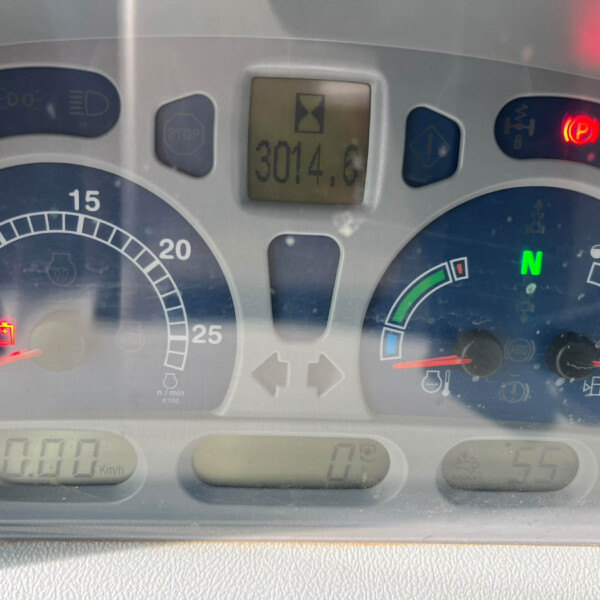 Car dashboard with central digital display showing 3014.6 km, red battery warning, and parking brake indicator.